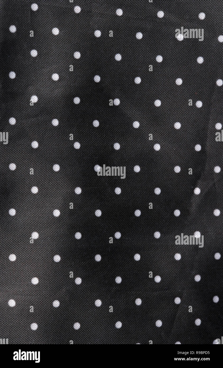 Tessuto nero lo sfondo con puntini bianchi Foto Stock