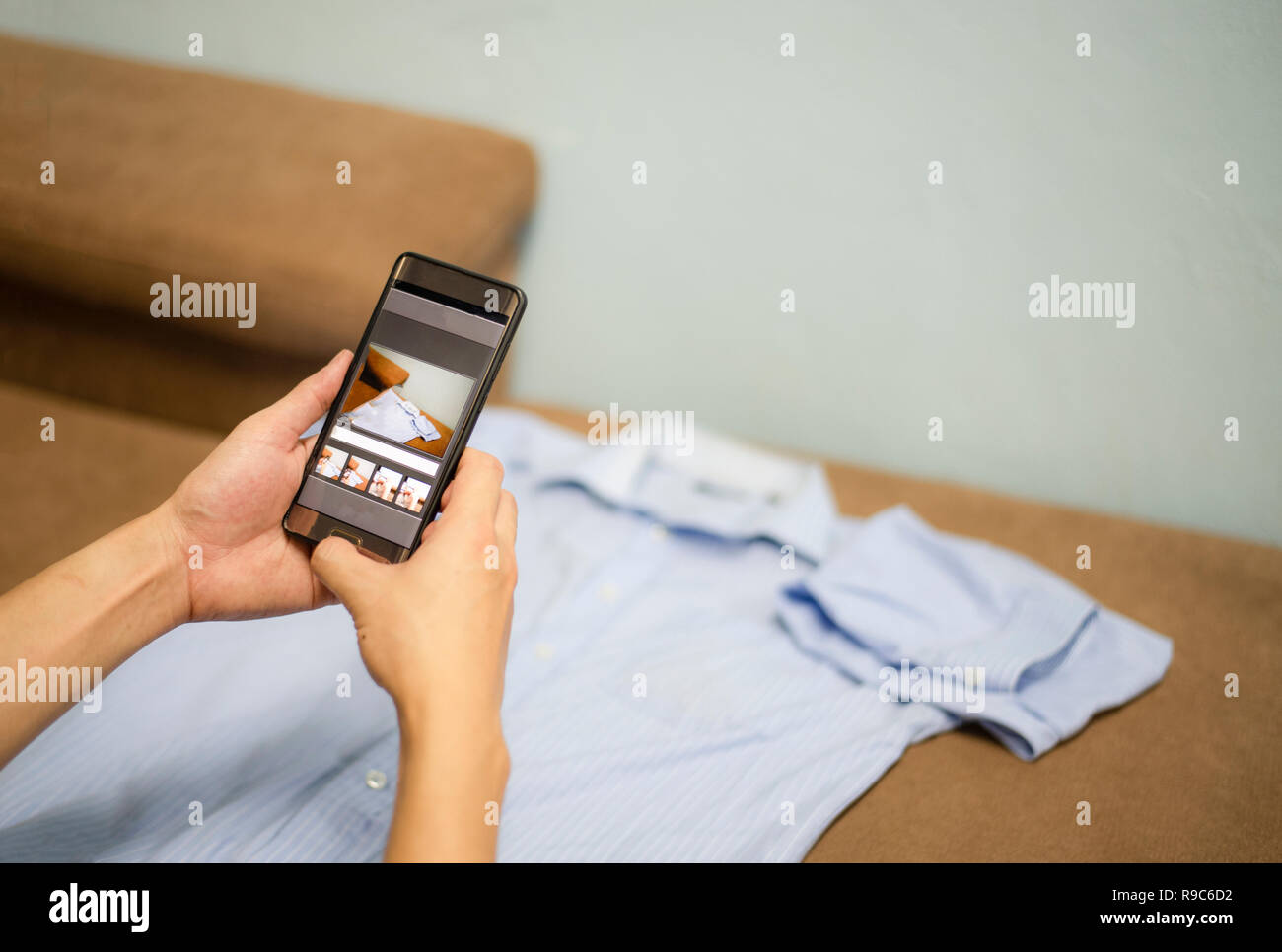 selling things online ecommerce shipping online shopping delivery and order concept / camera smartphone taking photo shirts for post to sell online in Foto Stock