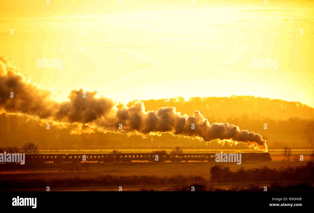 Peterborough, Regno Unito. 24 dicembre, 2018. La Vigilia di Natale Tornado treni a vapore sul Nene Valley Railway poteri che modo attraverso Nene Park appena prima del tramonto in Peterborough, CAMBRIDGESHIRE, il 24 dicembre 2018. Credito: Paolo Marriott/Alamy Live News Foto Stock