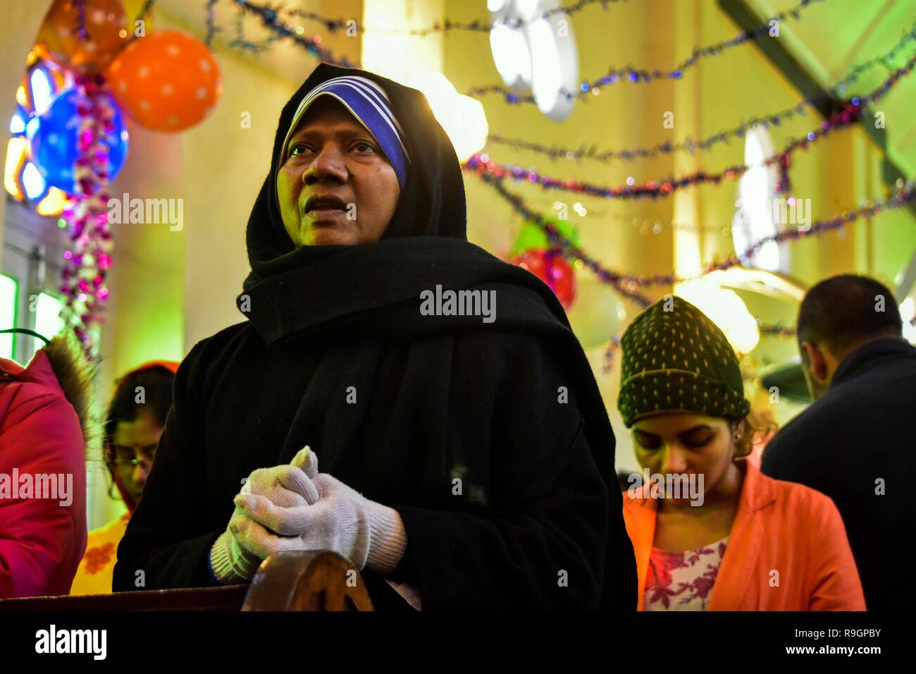 Dicembre 25, 2018 - Srinagar, J&K, India - Kashmir un cristiano prega all'interno della Santa Famiglia Chiesa cattolica in occasione del Natale a Srinagar, Indiano Kashmir amministrato. In mezzo a un freddo pungente in onda lo stato, la comunità cristiana della valle di martedì ha celebrato il Natale; il giorno della nascita di Gesù Cristo, con la scorza e allegria a Srinagar. Tra quelli che hanno pregato erano i turisti provenienti da diverse parti del paese che hanno aderito alla gente del posto per il giorno fausto e pregato per la pace in Kashmir e del resto del mondo. Credito: Saqib Majeed SOPA/images/ZUMA filo/Alamy Live News Foto Stock