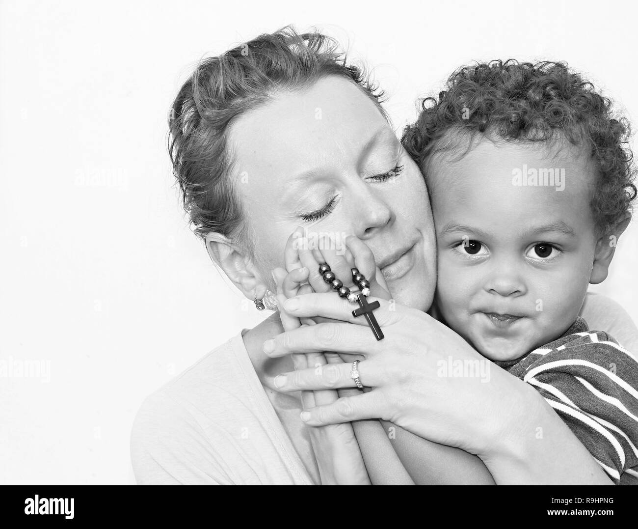 Madre e bambino che pregano insieme immagine di scorta e foto di scorta Foto Stock