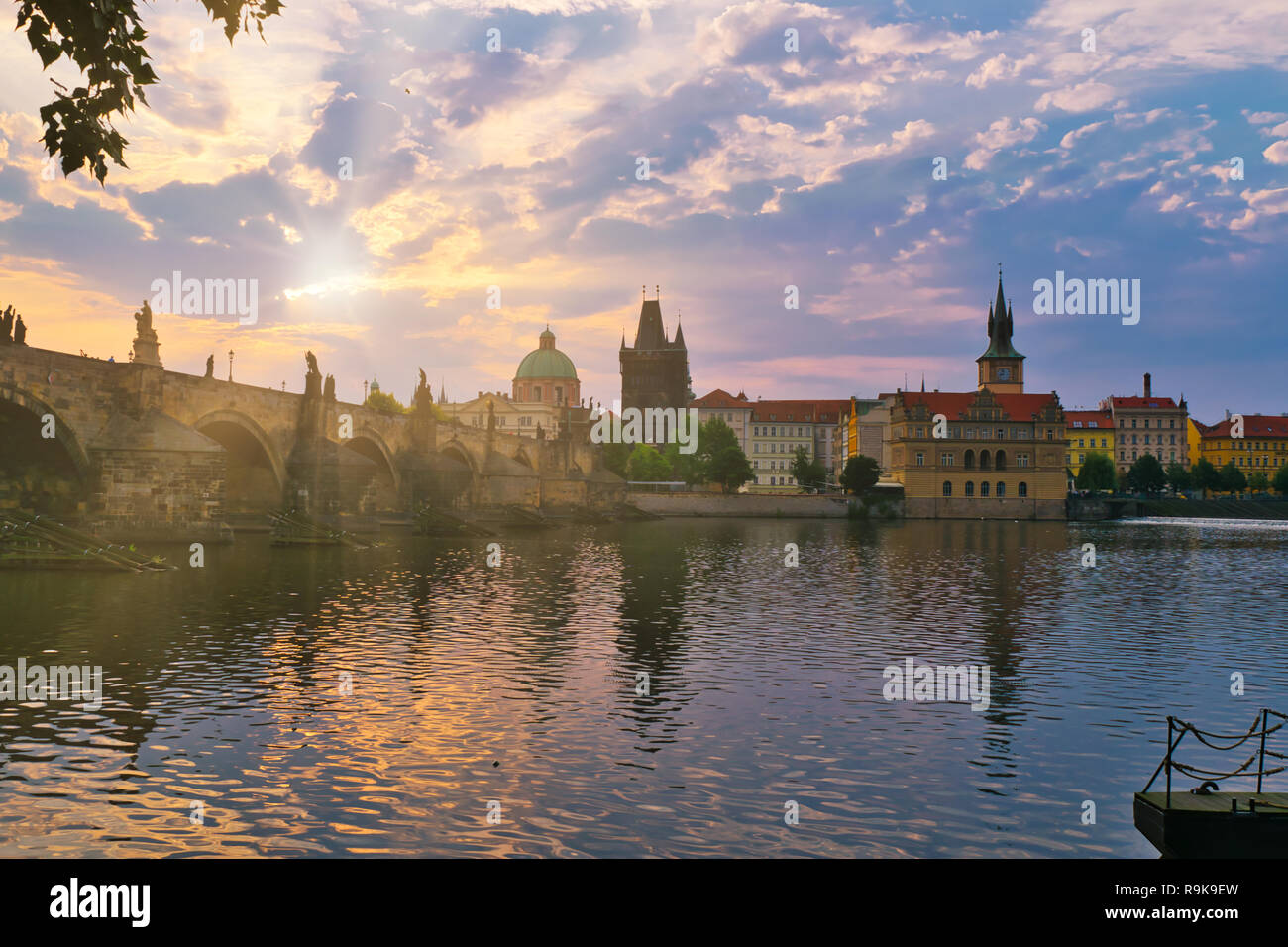 Alba al Ponte Carlo della città di Praga. Una fresca vista di mattina di Praga. Destinazione turistica per l'estate in Repubblica Ceca. Fogliame e paesaggio urbano. Foto Stock