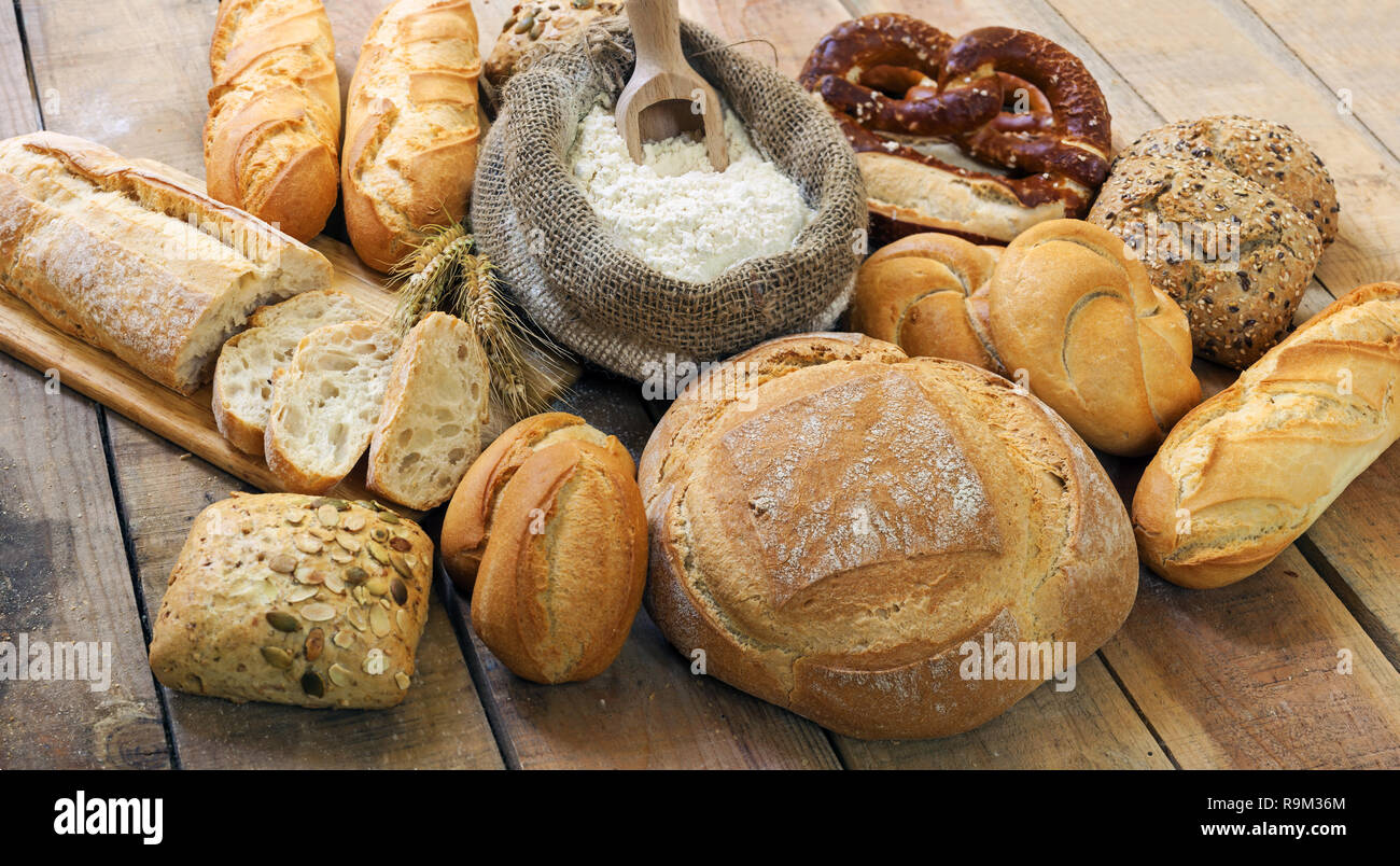 Vari tipi di pane su uno sfondo di legno Foto Stock