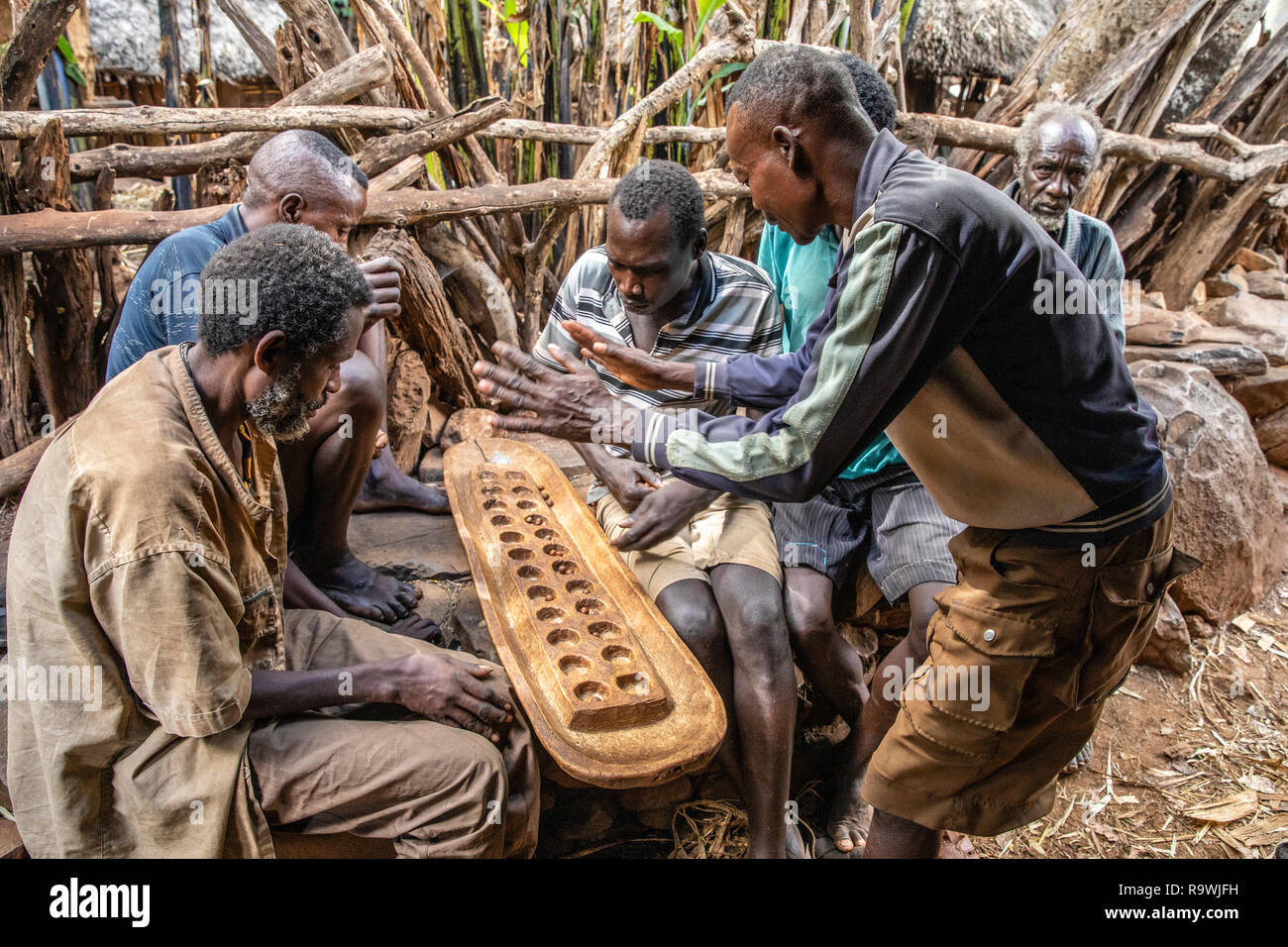 Tribù Konso giocando Gebeta, il più antico del mondo gioco di bordo, Valle dell'Omo, Etiopia Foto Stock