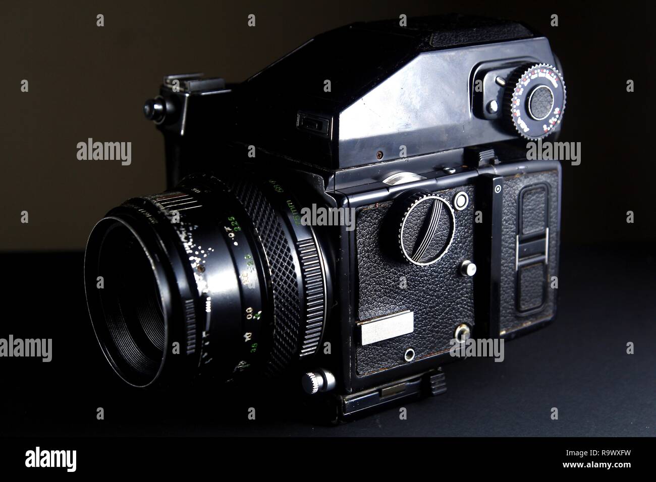 Un'annata medio formato fotocamera film girato con illuminazione drammatica e uno sfondo scuro. Foto Stock