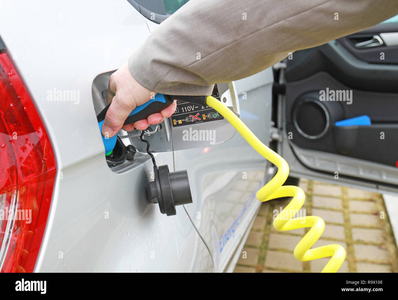 Ricaricare un'auto elettrica immagini e fotografie stock ad alta