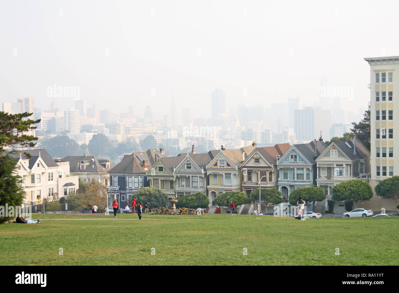 Painted Ladies case, San Francisco, preso da Alamo Square Park. Opacità del fumo da novembre 2018 incendi di foresta oscura sfondo skyline del centro Foto Stock