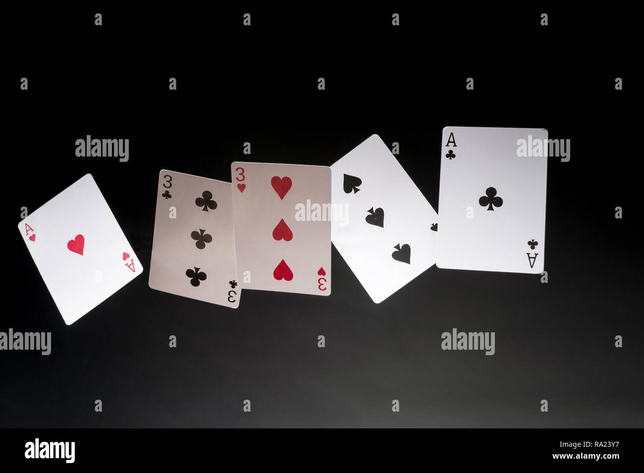 Flying giocando a carte su uno sfondo scuro - Full House Foto Stock