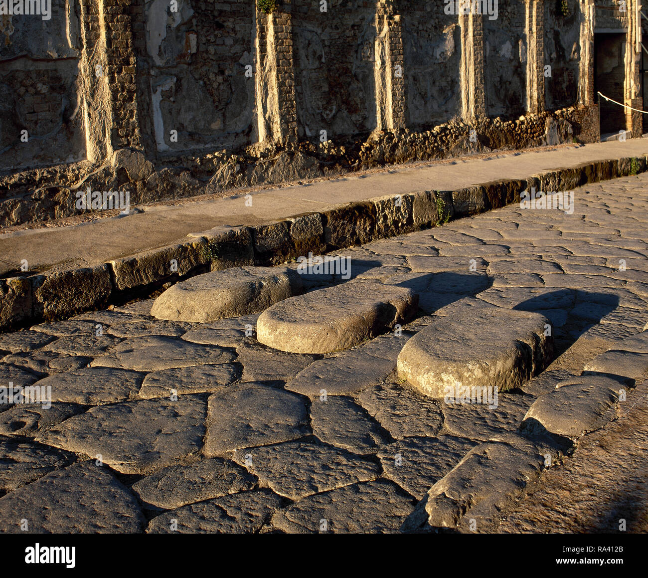 L'Italia. Pompei. Attraversamento pedonale di Via della Fortuna. Pietre miliari per i pedoni che attraversano la strada senza dirtyng i loro piedi. Pompei non ha avuto un adeguato liquame o sistema di drenaggio. Campania. Foto Stock