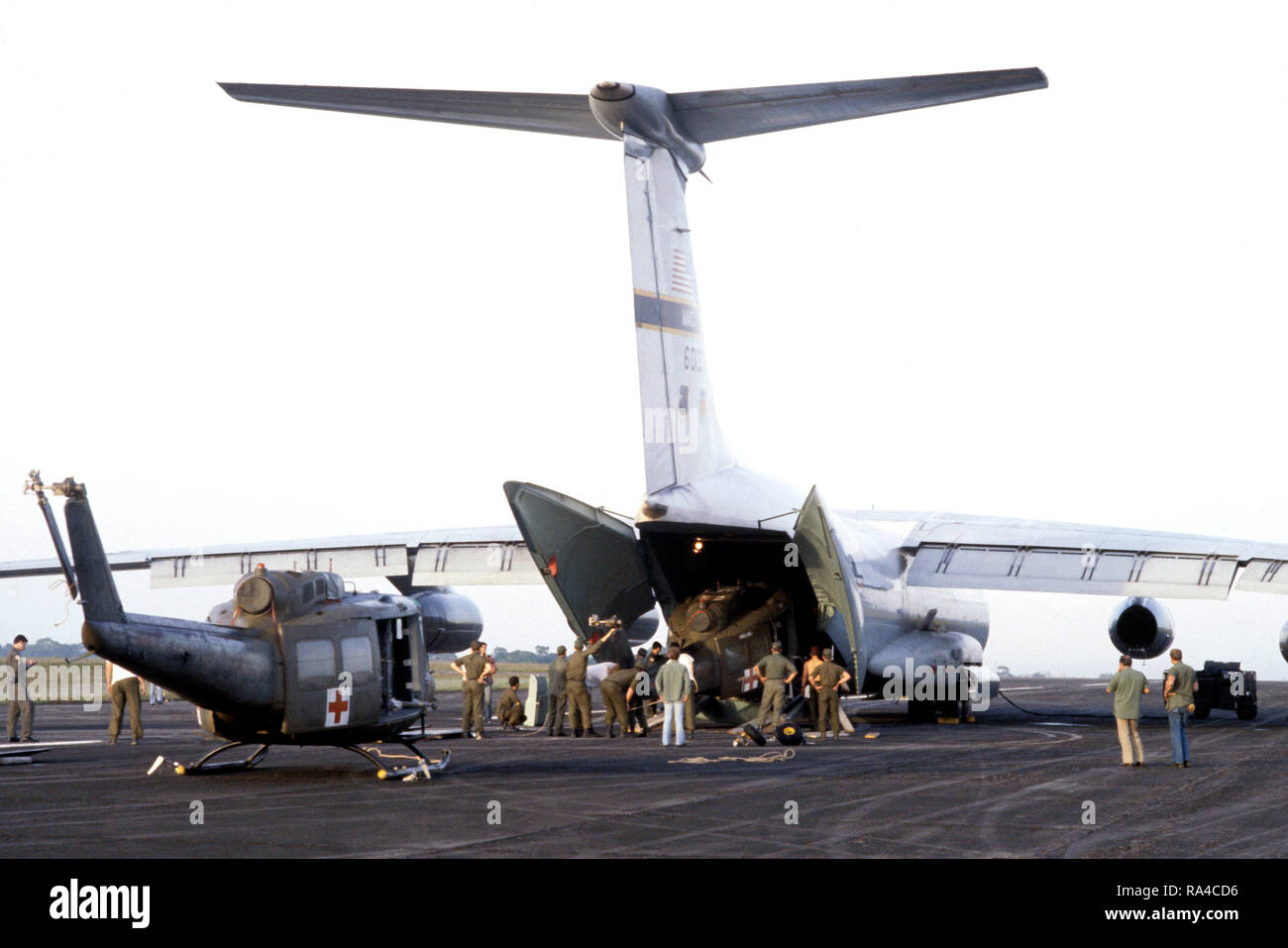 1978 - US Army UH-1 Iroquois elicotteri sono caricati a bordo di una C-141 Starlifter di aeromobili per il trasporto di ritorno alla loro casa di base nella zona del canale. Gli elicotteri erano stati utilizzati durante sforzo umanitario a seguito della tragedia di Jonestown. Foto Stock