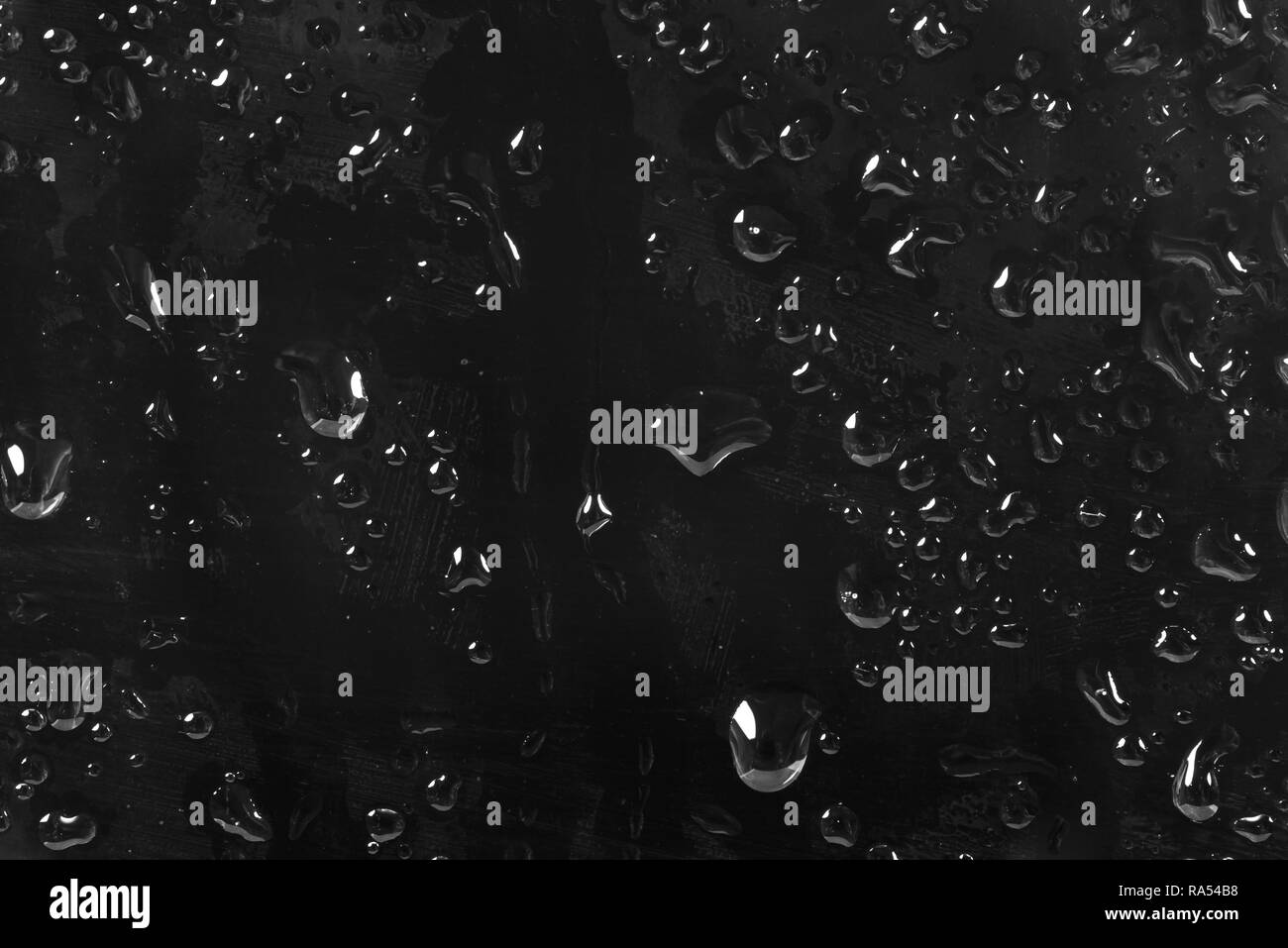 Abstract di nero sfondo costituito gocce di acqua su un vetro Foto Stock