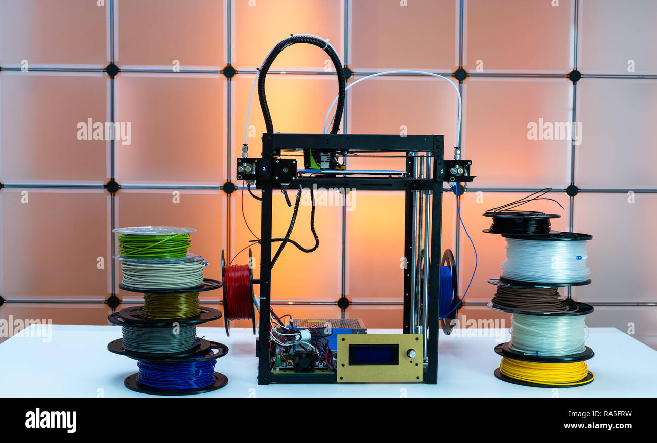 Stampante 3d e filamenti di plastica sul colore di sfondo Foto Stock