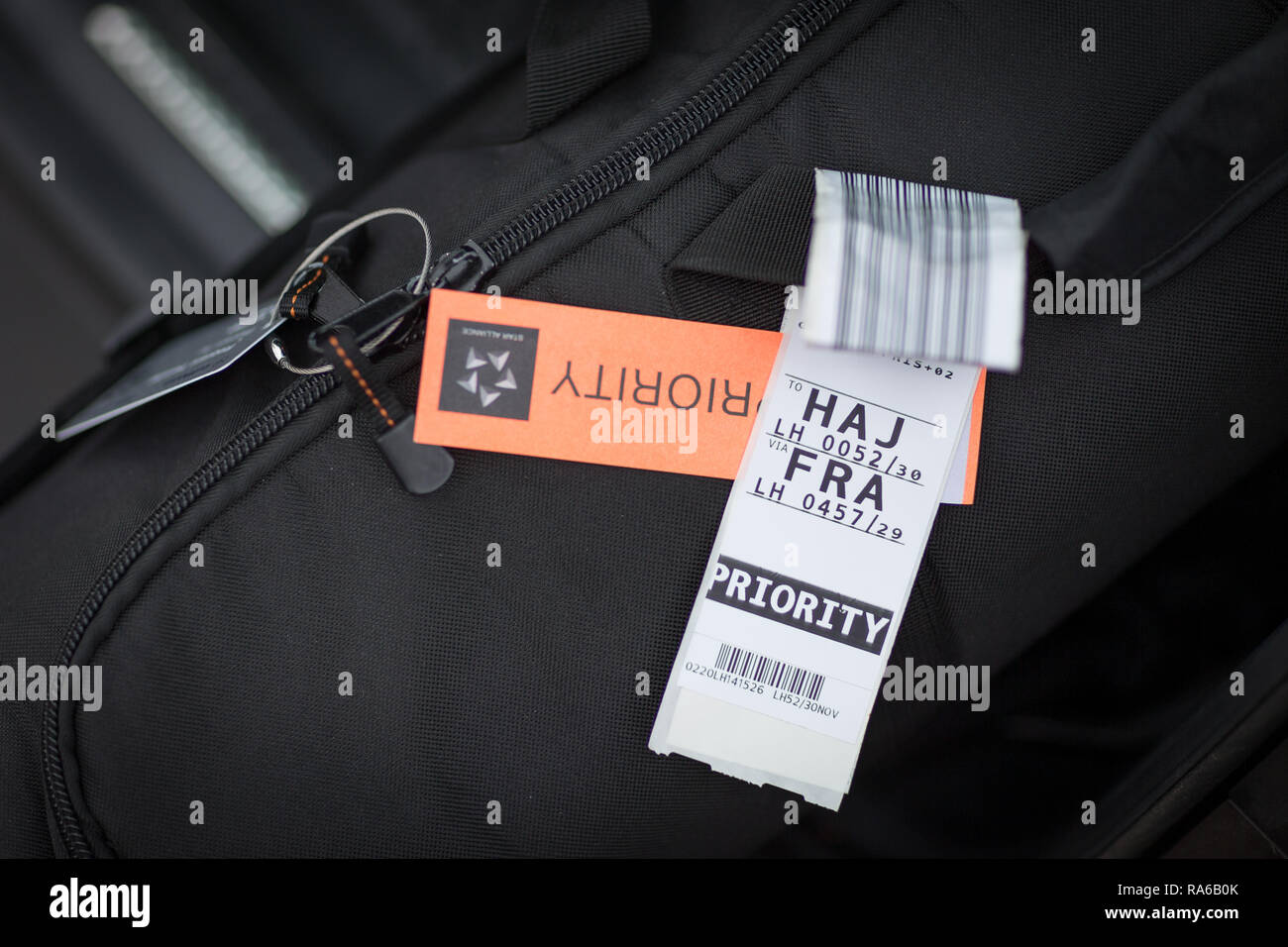 19 dicembre 2018, Bassa Sassonia, Osnabrück: Illustrazione - un bagaglio etichette con codici a barre si blocca sul manico di una borsa. L'introduzione di etichette RFID è destinato a garantire che un minor numero di pezzi di bagaglio sono persi in volo il bagaglio. Con l aiuto di un piccolo chip, che è integrato nell'usuale fascia, il Bagaglio Controllato per lâ imbarco possono essere trovati e identificati più facilmente. (Zu dpa 'bene sbarcati, valigia passati - con chip RFID contro la perdita di bagagli in volo") Foto: Friso Gentsch/dpa Foto Stock