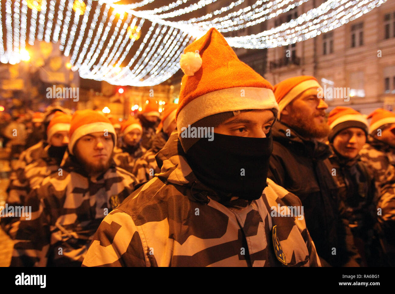 Un attivista del corpo nazionale ucraino partito nazionalista visto vestito in un costume di Babbo Natale con il suo volto coperto durante il rally. Ukrainian estrema destra gli attivisti si sono riuniti per un rally per contrassegnare il centodecimo anniversario del candidato ucraino Stepan Bandera la nascita. Stepan Bandera, a capo della organizzazione dei nazionalisti ucraini e fu uno dei leader della nazionale ucraina di movimento in Ucraina occidentale. Egli era responsabile per la proclamazione di indipendenza di uno Stato ucraino su 1941 a Lviv e fu assassinato su 1959 in Germania. Foto Stock