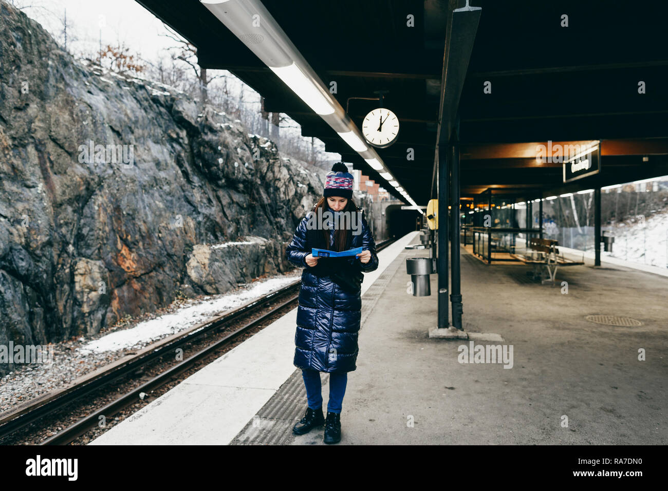 Lo stile di vita di viaggio. Giovane donna turistiche di Stoccolma guardando la mappa della metropolitana in piedi sulla piattaforma Foto Stock