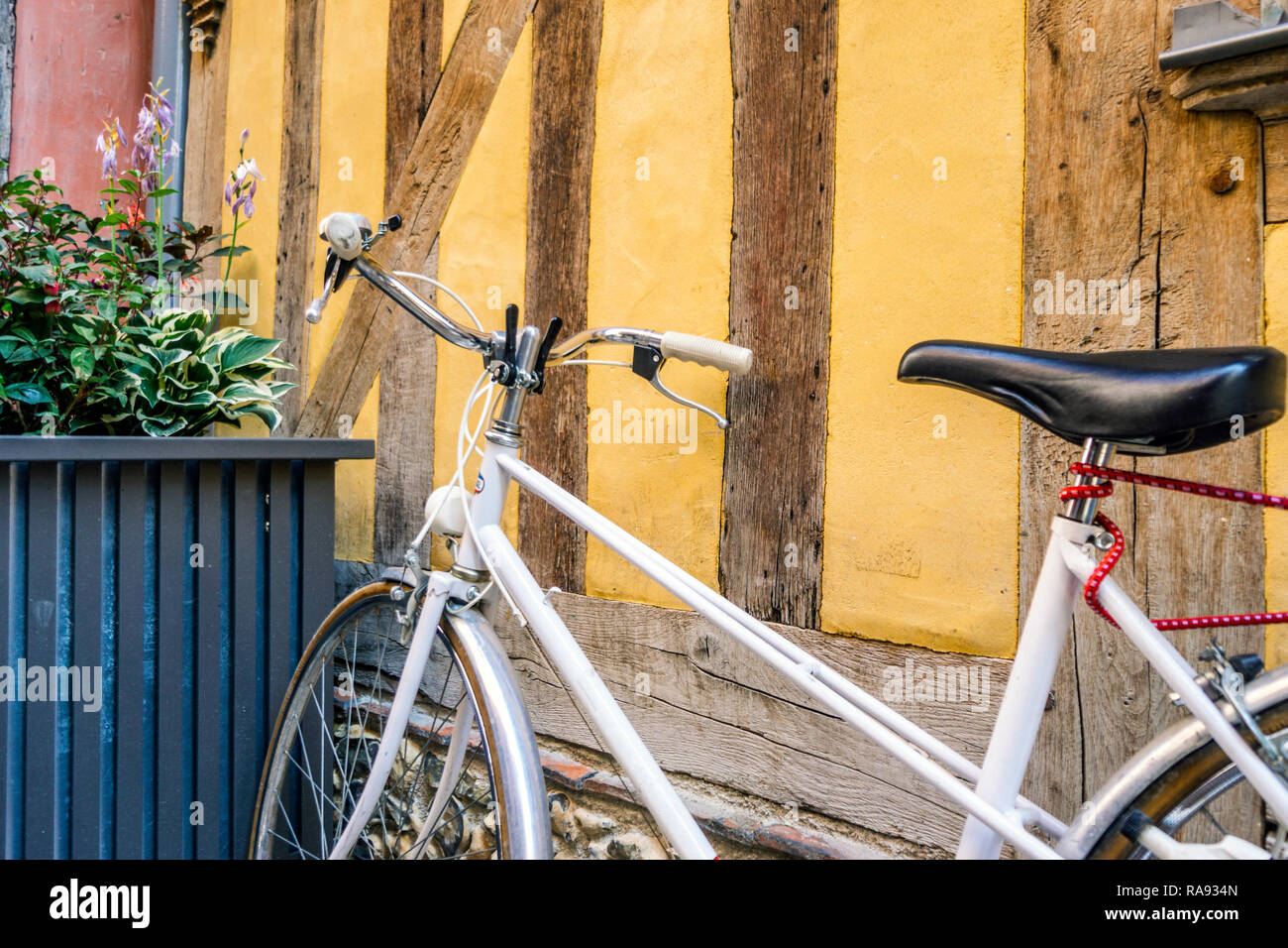 Vintage, bicicletta bianco nella parte anteriore del vecchio, giallo, graticcio casa di Troyes, Francia Foto Stock