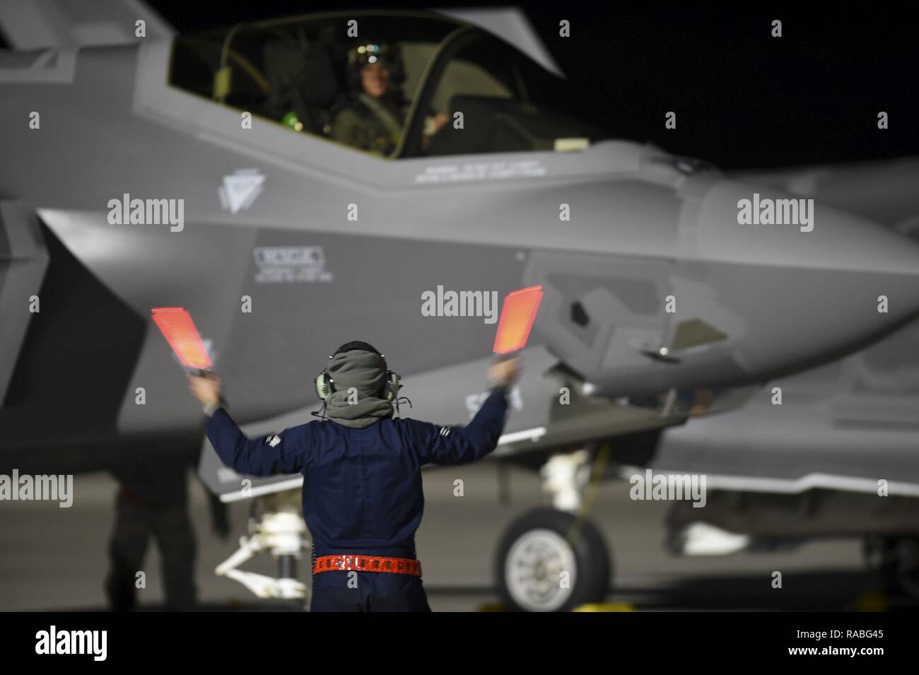 Un capo equipaggio esegue il marshalling di un F-35un fulmine II assegnato al 388 Fighter Wing, Hill Air Force Base in Utah, prima del decollo durante la bandiera rossa 17-1 presso la Base Aerea Militare di Nellis Nev., Gennaio 24, 2017. La F-35A è una quinta generazione di multi-ruolo di Stealth Fighter progettato per raccogliere, fusibili e distribuire più informazioni rispetto a qualsiasi altro combattente. Foto Stock