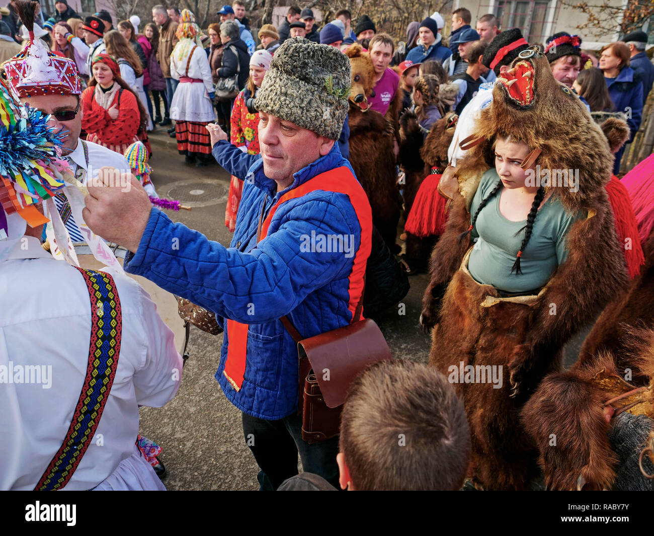 La gente vede riuniti per l'evento. Alla fine dell'anno e l'anno nuovo giorno í, persone in Trotus Valley in Romania abito in pelli di orso e danza per inseguire tutto il male e portare la felicità e la benedizione per la gente del villaggio. In passato, Roma persone sono state sollevando orsi selvatici ed eseguita con loro per guadagnare soldi. La gente crede che la porta è in grado di guarire le malattie e di portare la forza per loro. Dopo mantenendo la porta è stata proibita la gente ha cominciato a ballare in orso skin per mantenere il nuovo anno la tradizione. Il prezzo di una pelle può essere alta come 3000 euro. Foto Stock