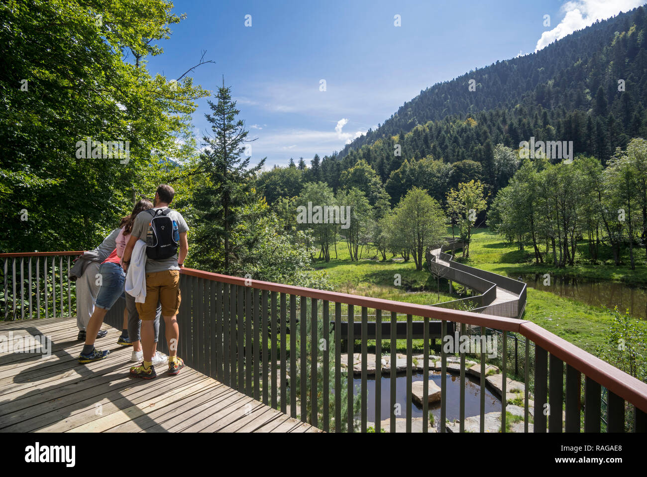 I visitatori sulla piattaforma alla ricerca di animali nel grande contenitore di animale allo zoo Aran Park, il giardino zoologico a Bossost, Lleida, Pirenei, Catalogna, Spagna Foto Stock