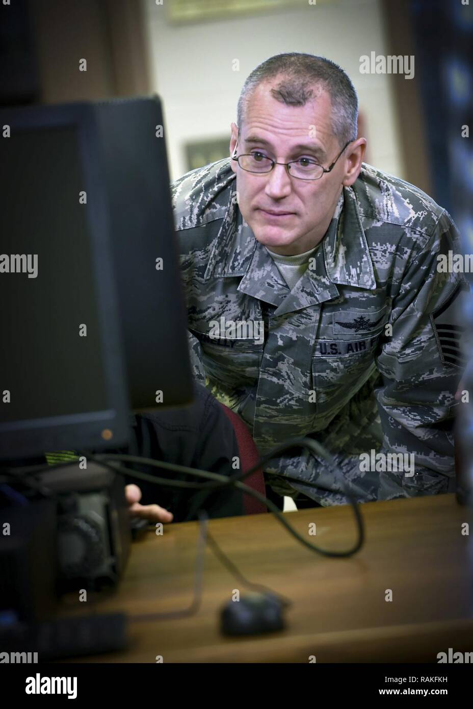 Master Sgt. Michael Connelly, membro dell'273a operazioni di informazione Squadron, Texas Air National Guard, aiuta a uno studente e Cyber Patriot membro del team con cyber security a Floresville High School 14 Febbraio, 2017. Squadron deputati sono state partecipando a Floresville del Cyber Patriot programma, un'iniziativa per insegnare agli studenti come fare per identificare il sistema di rete le vulnerabilità e le minacce. (Air National Guard Foto Stock