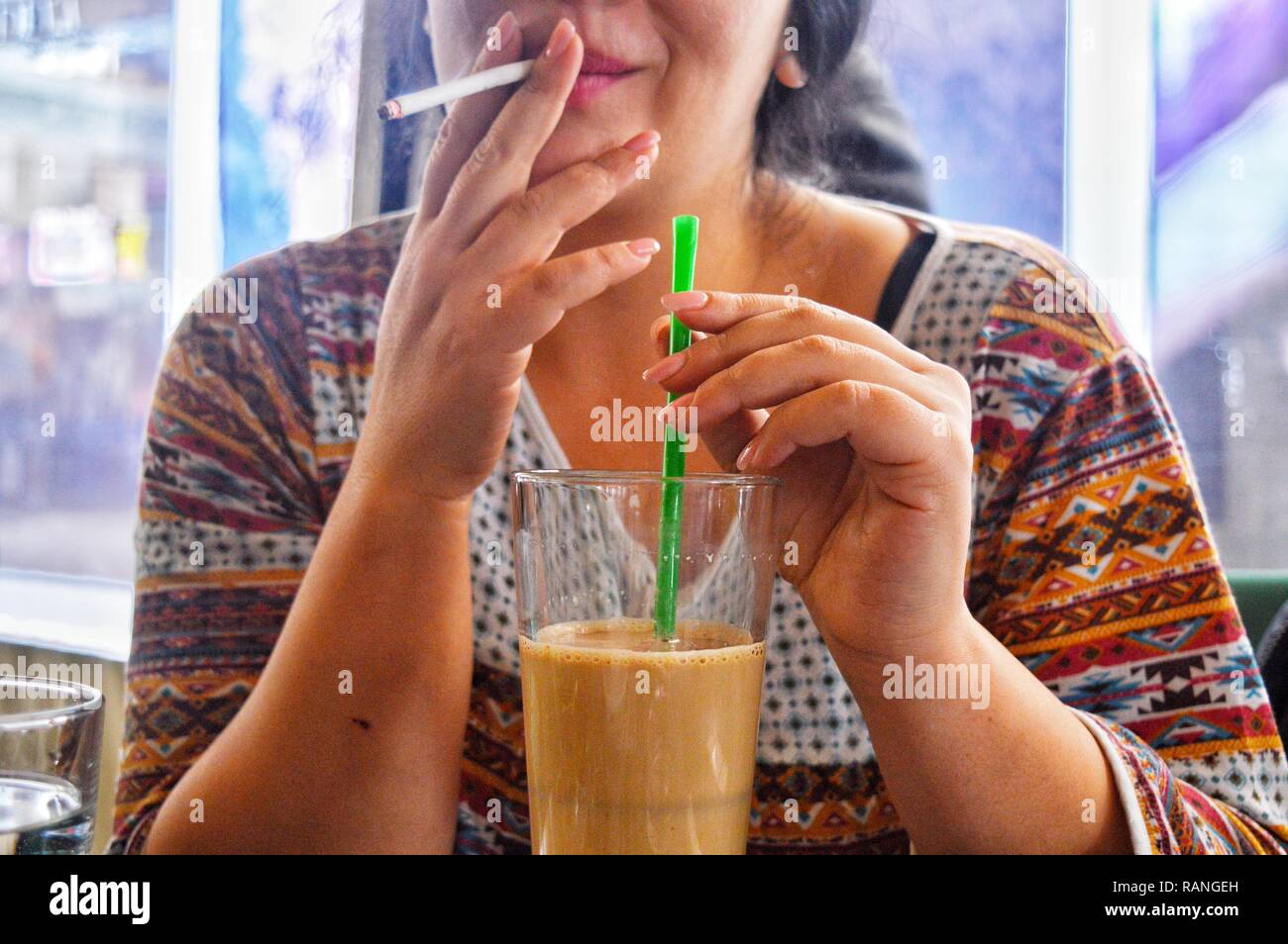 Una persona di bere il caffè in un bar Foto Stock