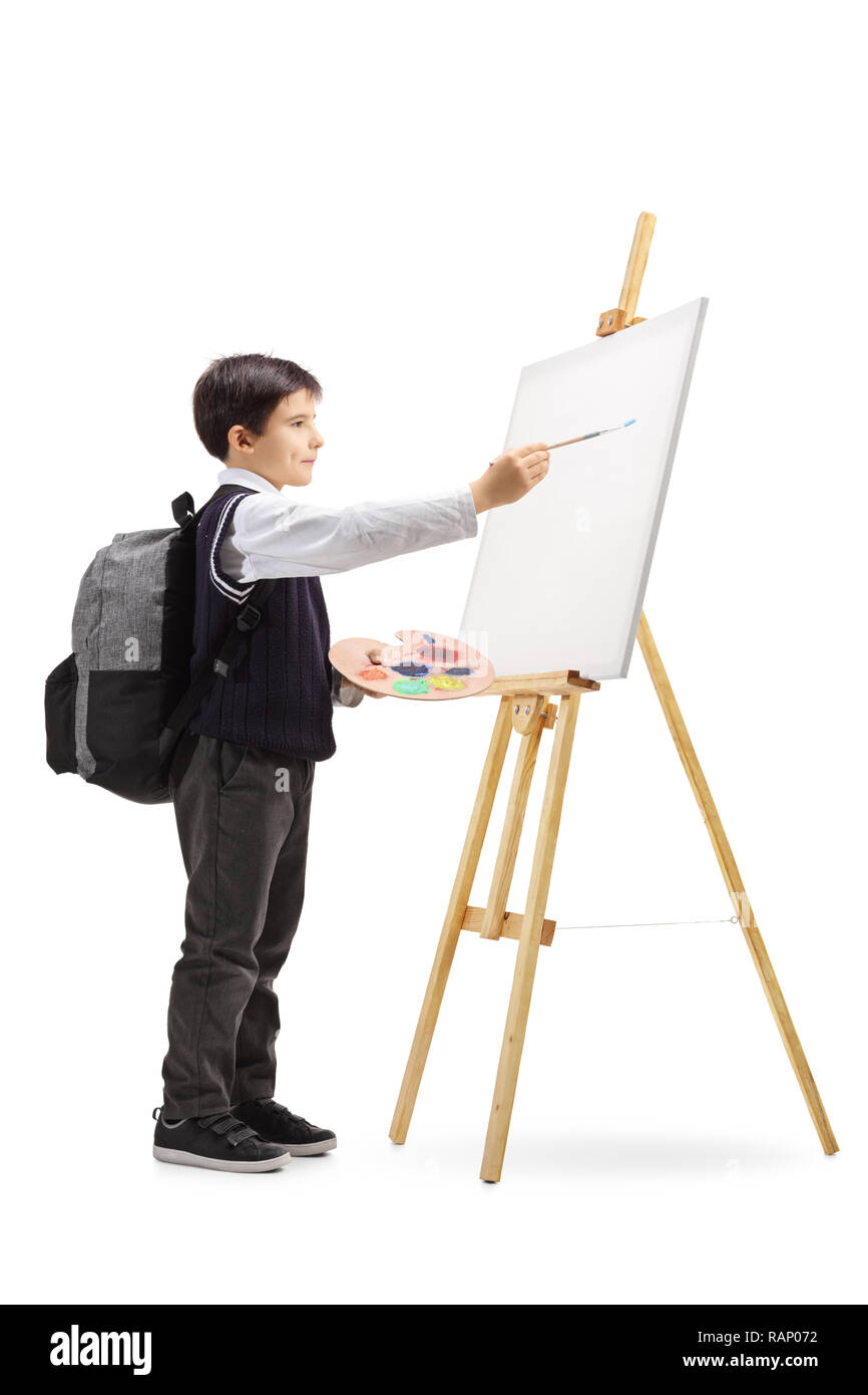 A piena lunghezza shot di uno scolaro dipinto su una tela isolati su sfondo bianco Foto Stock