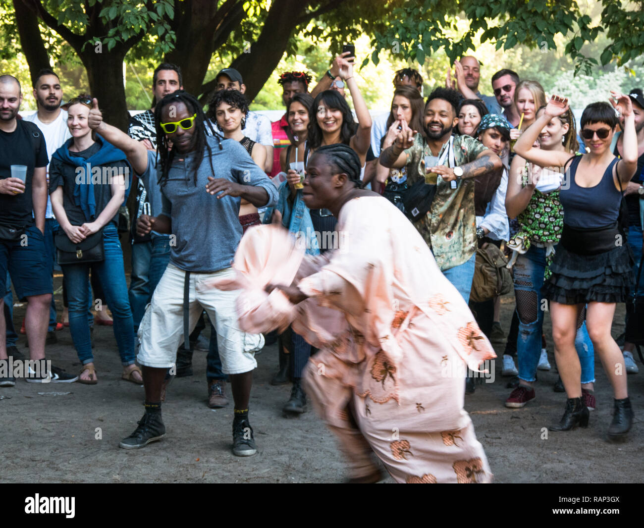 Berlino, Germania - 20 Maggio 2018: la gente ballare la musica africana e celebrando Kreuzberg Il Carnevale delle culture nella polverosa la luce del tramonto Foto Stock