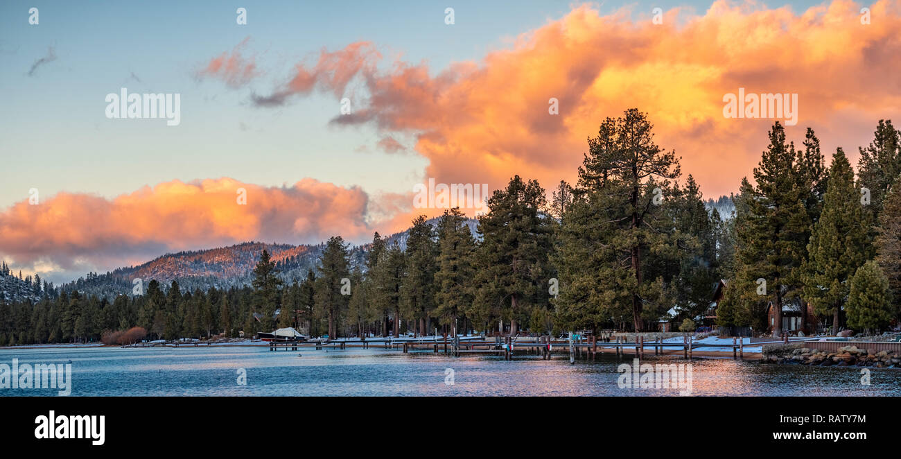 Splendide vedute del tramonto del litorale di South Lake Tahoe, case visibile tra alberi di pino Foto Stock