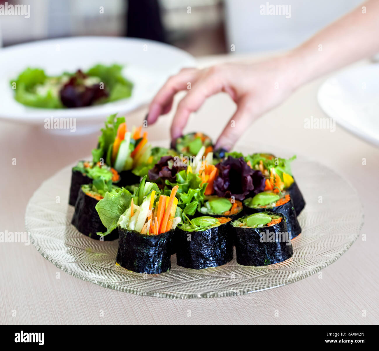 Materie vegano rotoli di sushi con verdure e salsa verde nel ristorante Foto Stock