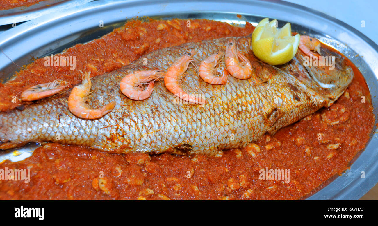 Di stile marocchino pesce è servita nel matrimonio. Il pesce con la salsa di pomodoro Foto Stock
