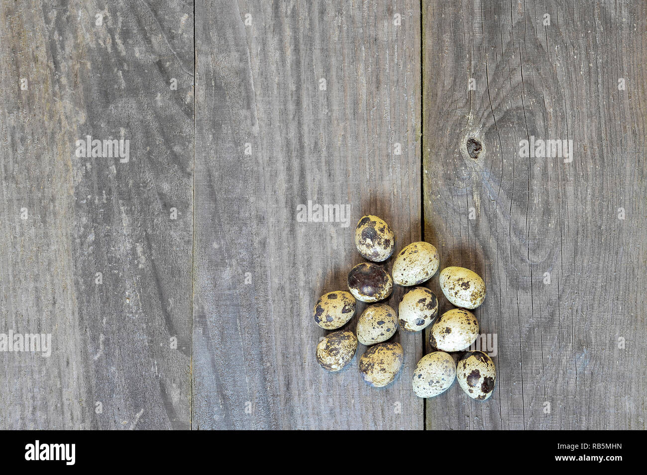 Uova di quaglia laici in una pila su una tavola di legno sfondo vintage. Il concetto di mangiare sano i vantaggi Foto Stock