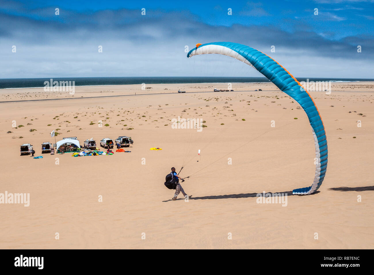 Parapendio oltre le dune del deserto del Namib, Long Beach, Swakopmund, Namibia Foto Stock