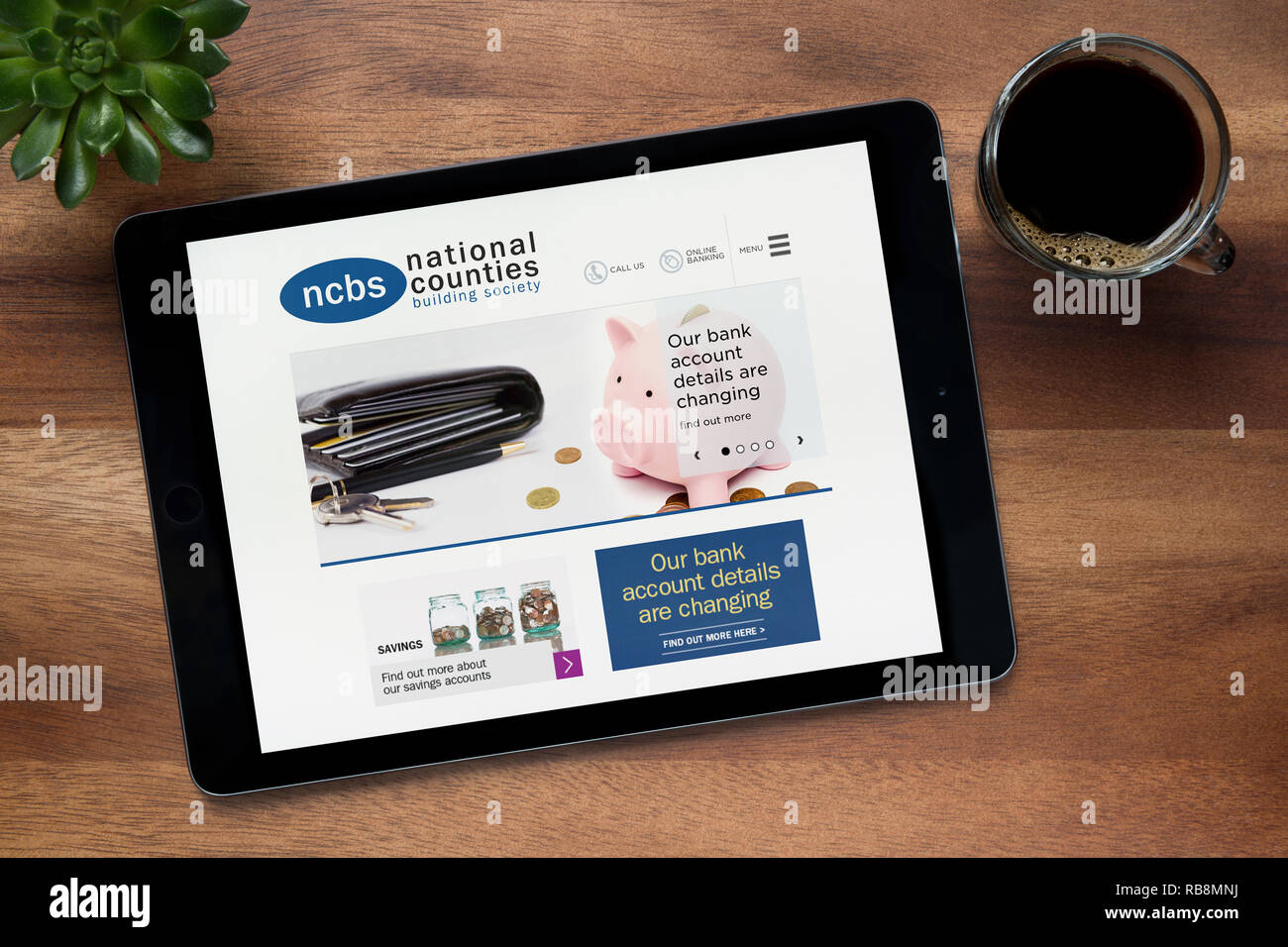 Il sito Web della National Counties Building Society è visto su un tablet iPad appoggiato su un tavolo di legno (solo uso editoriale). Foto Stock