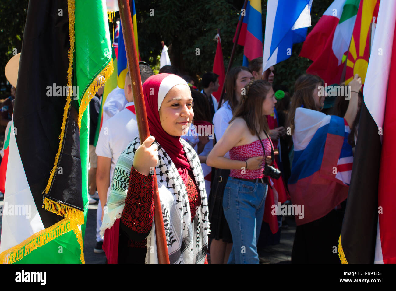 Una bella foto di una tradizionale donna palestinese marciare con la bandiera nazionale Foto Stock
