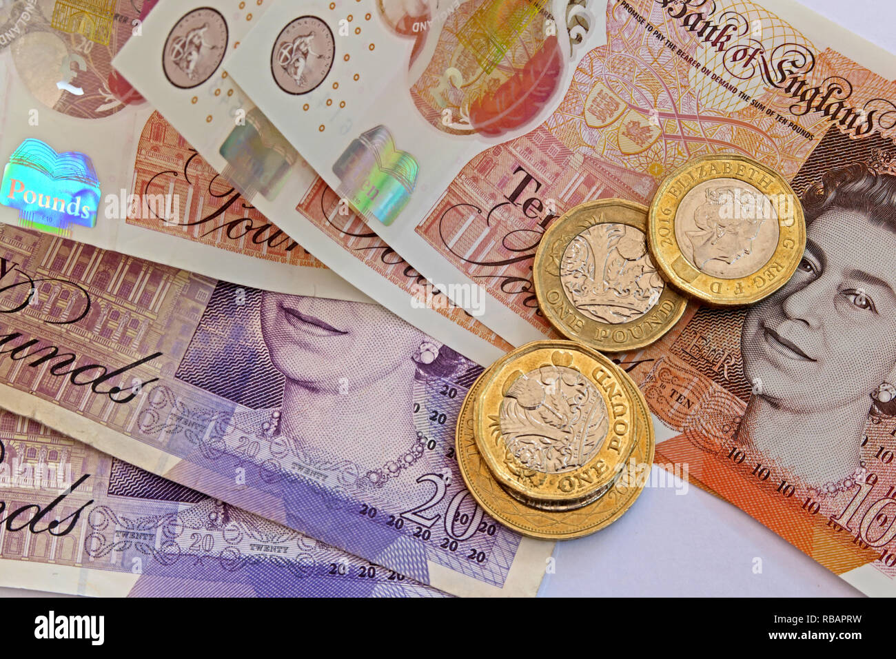 Banca d'Inghilterra in plastica 5 sterline £10 Cinque pound e dieci libbre di banconote e di monete Foto Stock