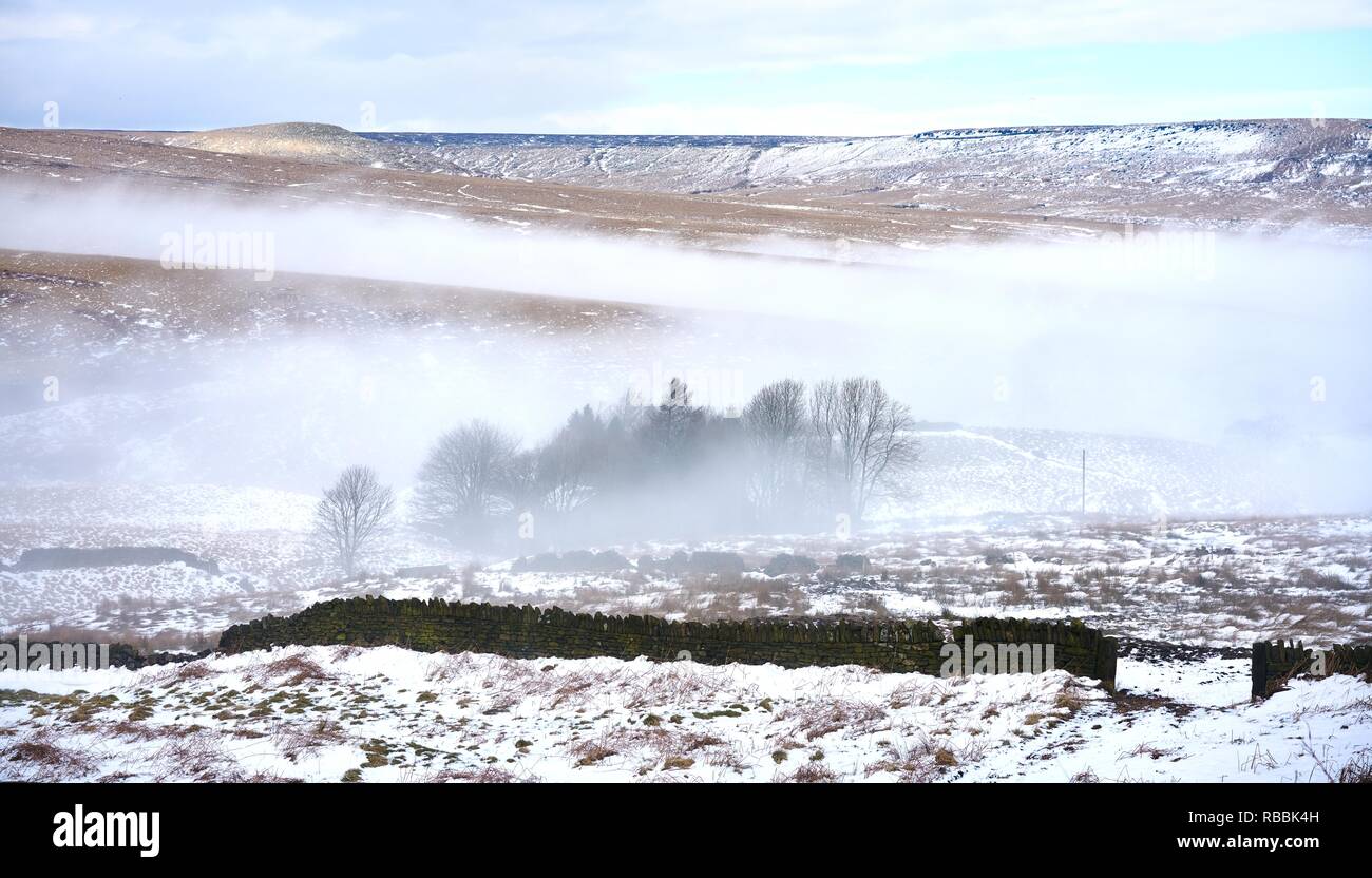 Neve e basse nubi nelle valli del Pennine hills, Inghilterra nel periodo invernale Foto Stock