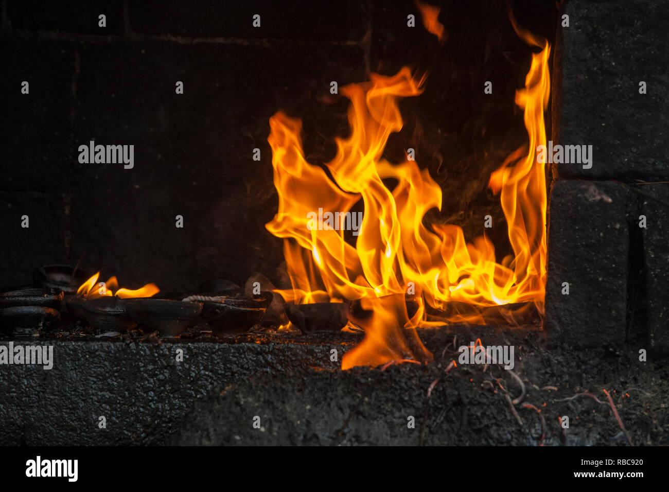 Le fiamme da lampade ad olio al tempio buddista Foto Stock