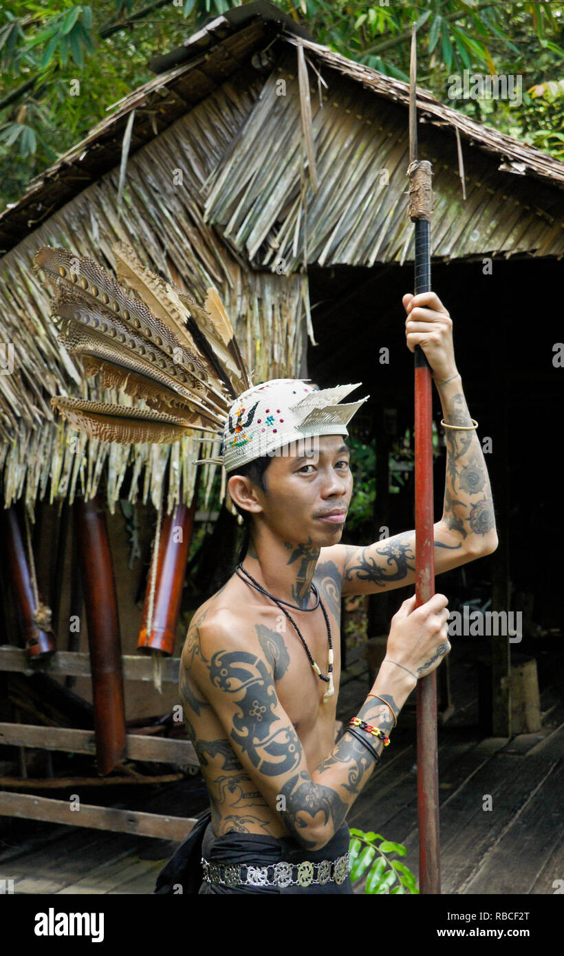 Tatuato Penan uomo tribale con lancia Sarawak Villaggio Culturale, Kuching, Sarawak (Borneo), Malaysia Foto Stock