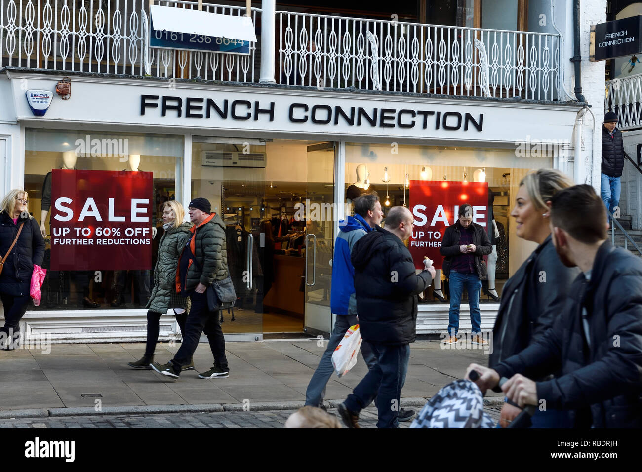 Gli amanti dello shopping a piedi passato il Chester il ramo di collegamento francese con segni di vendita nella finestra Foto Stock