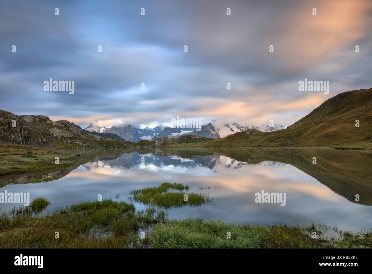 Le cime innevate sono riflesse nei laghi Fenetre all'alba Ferret Valley Saint RhÃ©mio Gran San Bernardo Valle d'Aosta Italia Europa Foto Stock