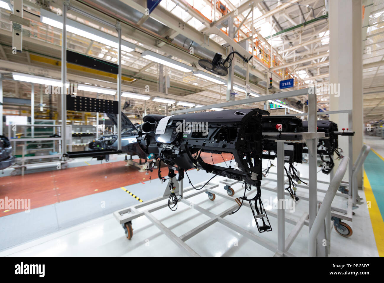 Aggiungere dettagli al corpo vettura. Le attrezzature di robotica rende il montaggio della macchina. Auto moderna il montaggio in fabbrica Foto Stock