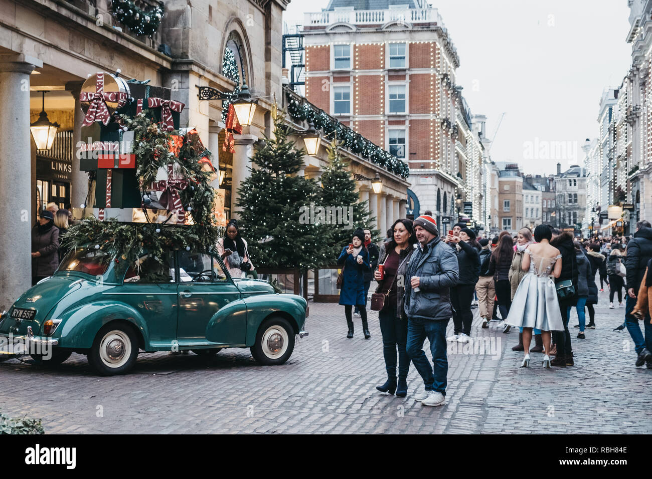 London, Regno Unito - 21 Novembre 2018: la gente camminare passato e scattare le foto di una vettura di decorazioni di Natale nel mercato di Covent Garden, uno dei più popolari Foto Stock