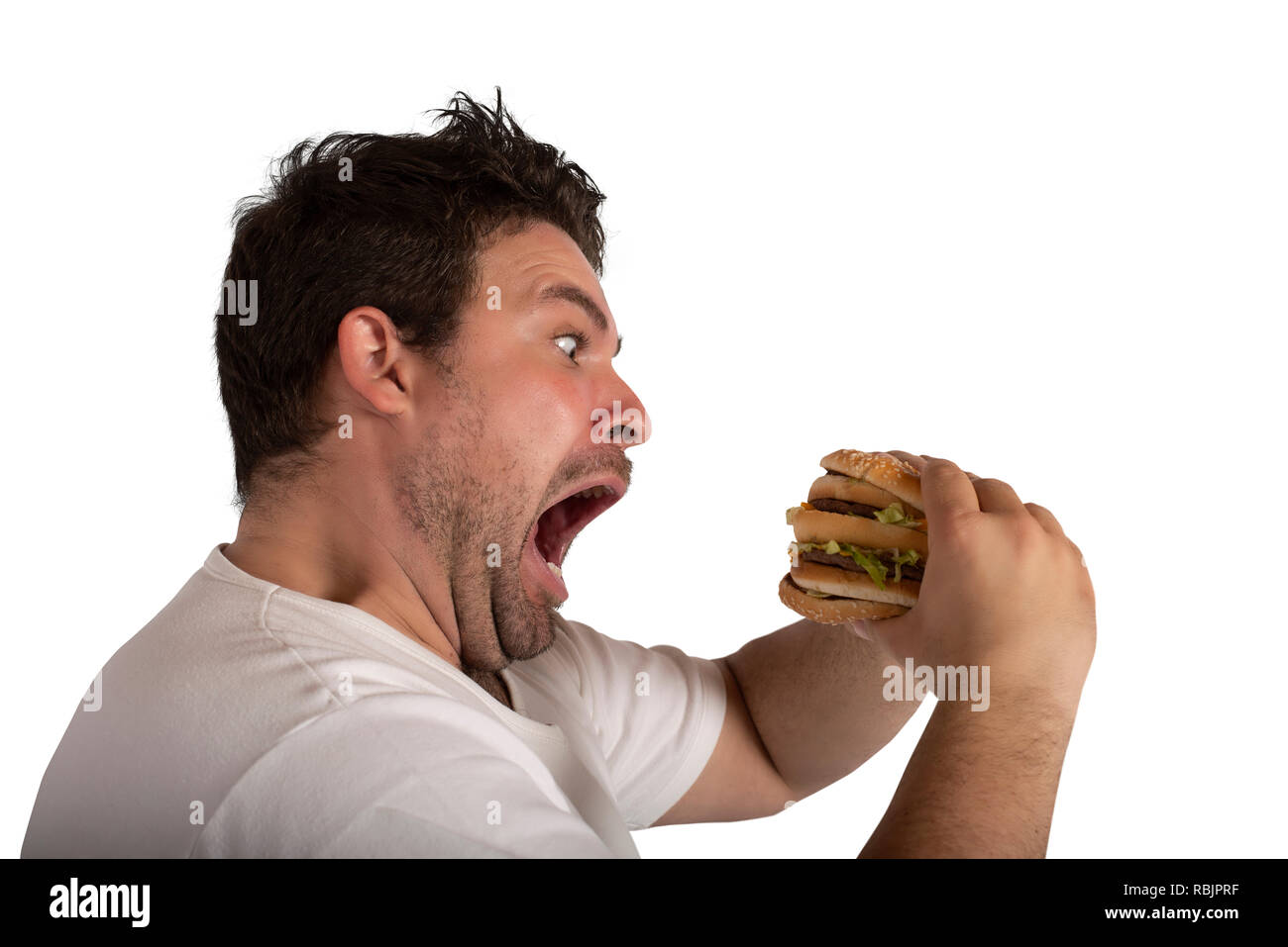 E insaziabile fame uomo mangiare un panino Foto Stock