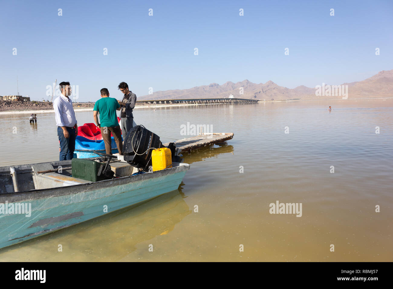 Un barcaiolo con la sua barca sulla spiaggia del lago di Urmia, West Azerbaijan provincia, Iran Foto Stock