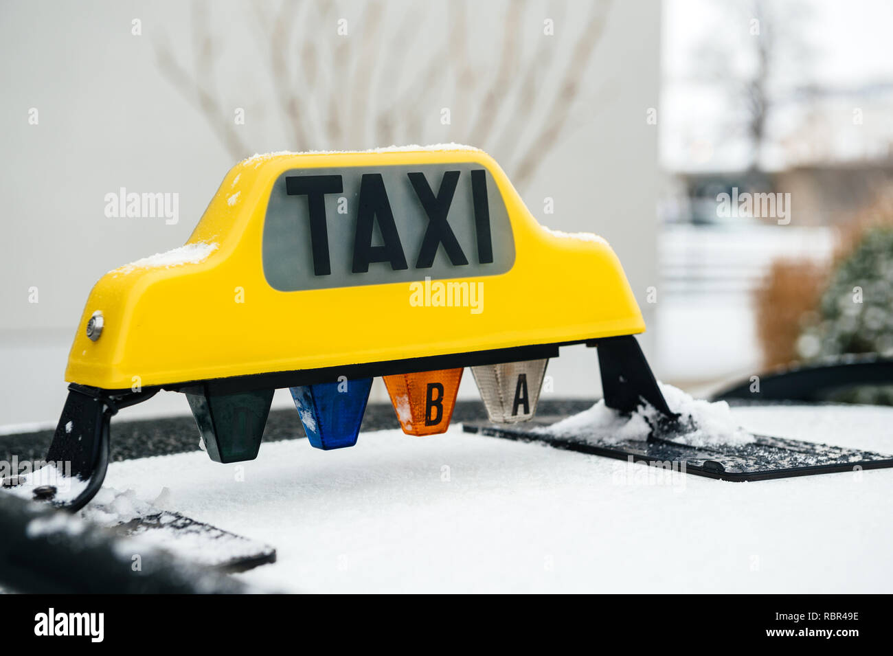 Vista laterale del giallo taxi segno coperte di neve in una fredda giornata invernale Foto Stock