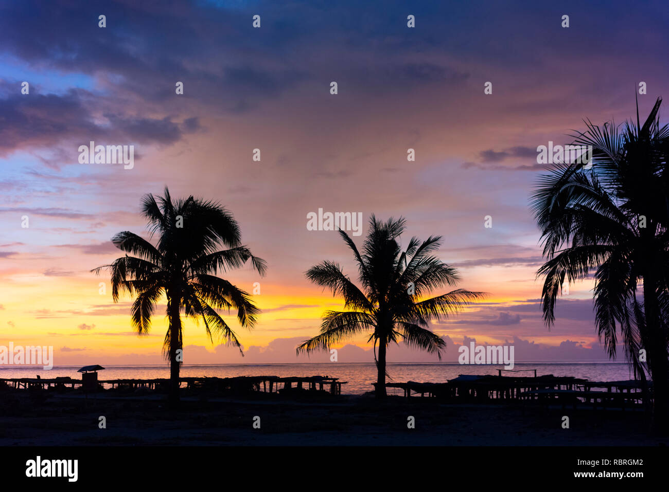 Sulla spiaggia, sull'oceano, palme, stendini e tramonto a Nemberala Rote sull isola. Foto Stock