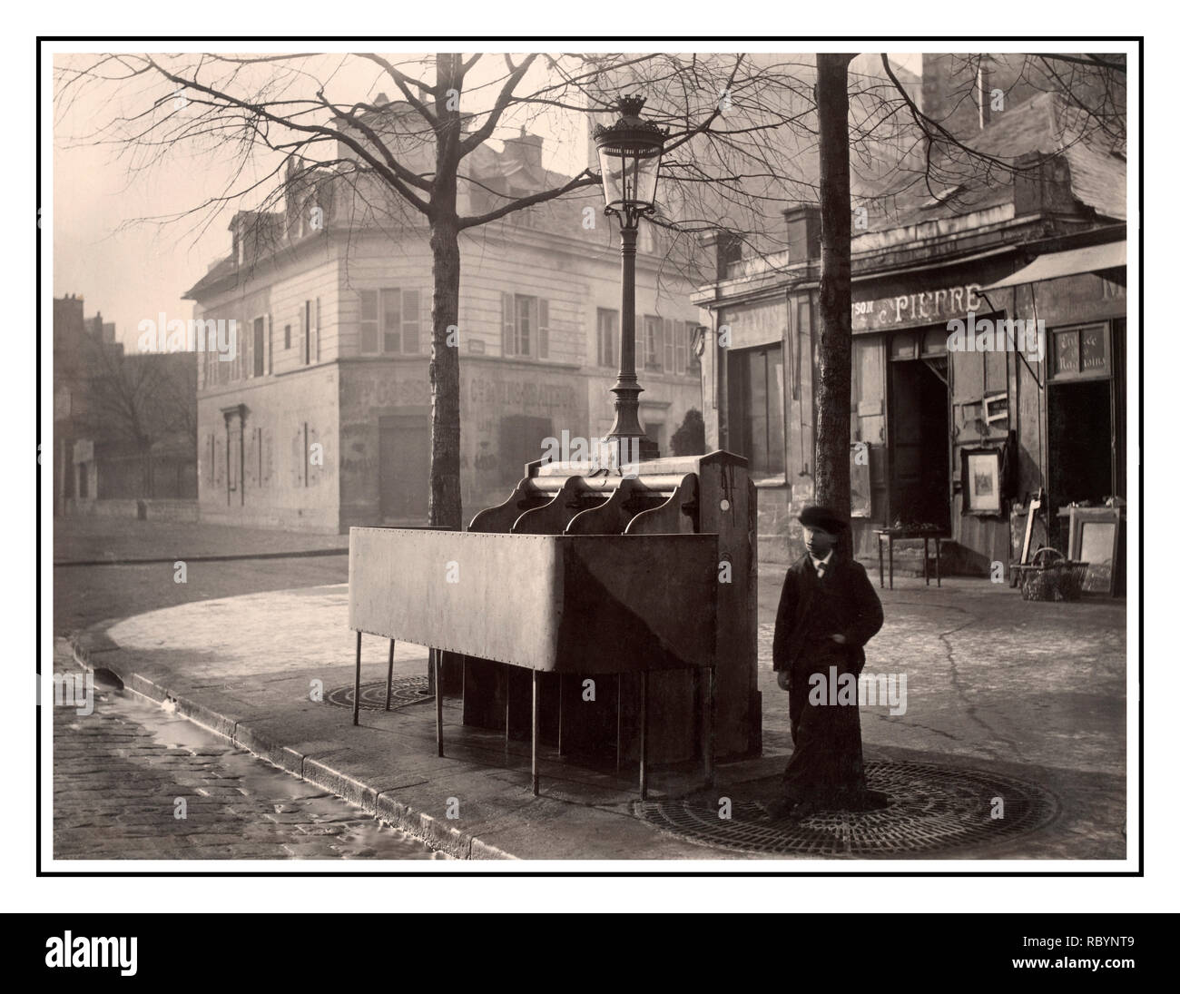 Vintage B&W francese "Pissoir' 'Uritrottoir" tipici Parigi storica strada uomini orinatoio ghisa e ardesia orinatoio con tre bancarelle sollevato modestia, schermo montato con il lampione e la lanterna.Con un giovane uomo in piedi vicino a. Avenue du Maine, Paris, Francia. Data circa 1865 Charles Marville fotografo (1813-1879) Foto Stock