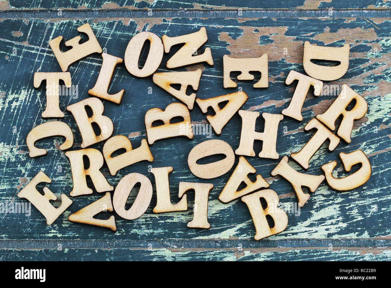 Lettere di legno sparsi sul rustico superficie in legno Foto Stock