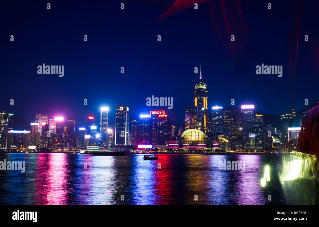 Hong Kong - Agosto 7, 2018: Hong Kong cityscape vista di moderni edifici del centro per l'acqua da Victoria Harbour di notte Foto Stock