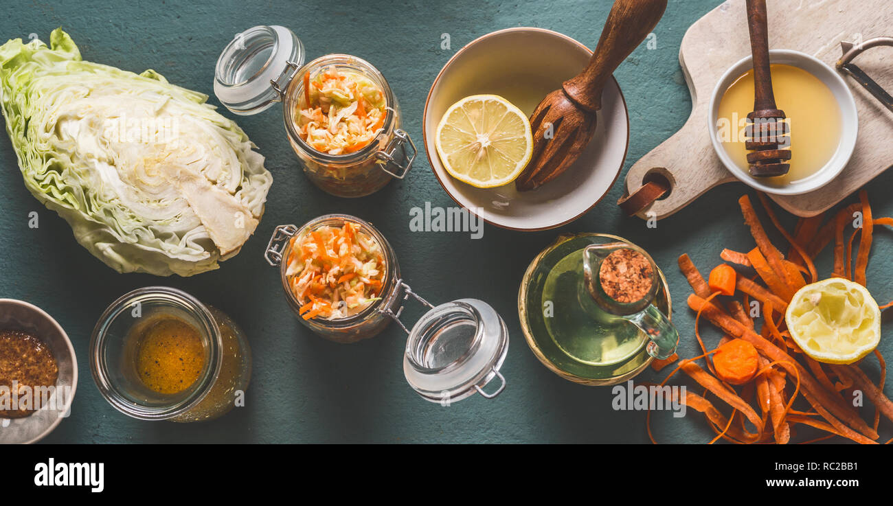 Un trito di insalata di cavolo in vasetti per un sano pranzo con gli ingredienti sul tavolo da cucina sfondo, vista dall'alto, con copia spazio. Cibo vegetariano, a basso contenuto calorico Foto Stock